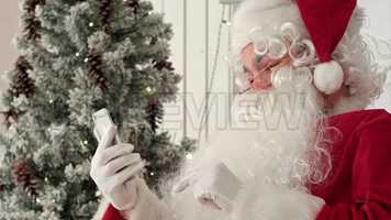 Free download Santa Claus Uses Phone Stock Video video and edit with RedcoolMedia movie maker MovieStudio video editor online and AudioStudio audio editor onlin