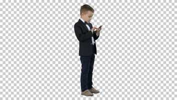 Free download Young boy in elegance suit playing with mobile phone, Alpha Channel | Stock Footage - Videohive video and edit with RedcoolMedia movie maker MovieStudio video editor online and AudioStudio audio editor onlin